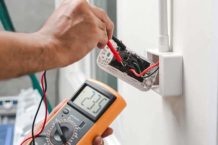 An Ehman Electric electrician wiring a bright modern kitchen in a Port St. Lucie home